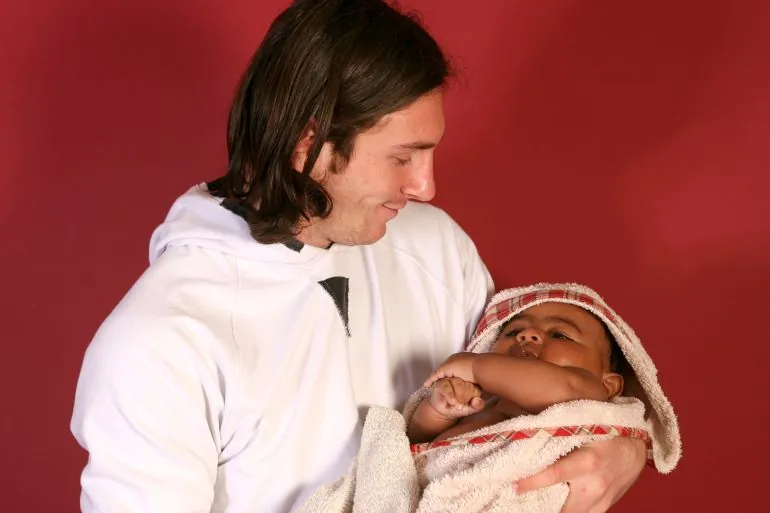 This photo taken in Sept. 2007 shows a 20-year-old Lionel Messi, who had embarked on his legendary Barcelona career just over four years prior, cradling Lamine Yamal, who was merely six months old at the time during a photo session in the dressing room of the Camp Nou stadium in Barcelona, Spain. Lamine Yamal is now a soccer sensation for both Spain and Barcelona and he is still only 16-years-old. (AP Photo/Joan Monfort)